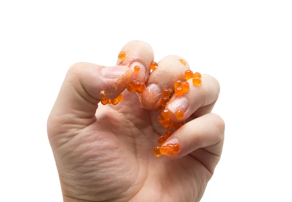 Mão em caviar vermelho no fundo branco — Fotografia de Stock