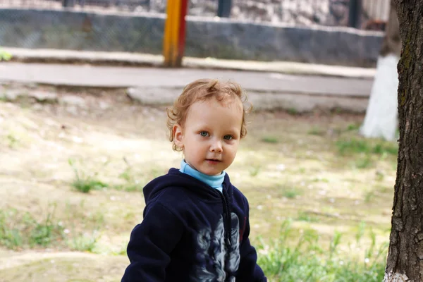 Curly-haired boy in the park — Stock Photo, Image