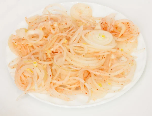 Onions sliced rings with pepper — Stock Photo, Image