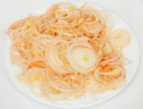 Onions sliced rings with pepper — Stock Photo, Image
