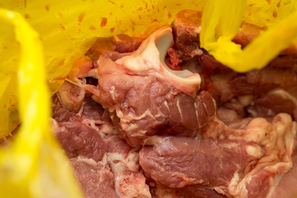 Fresh pork in a yellow package — Stock Photo, Image