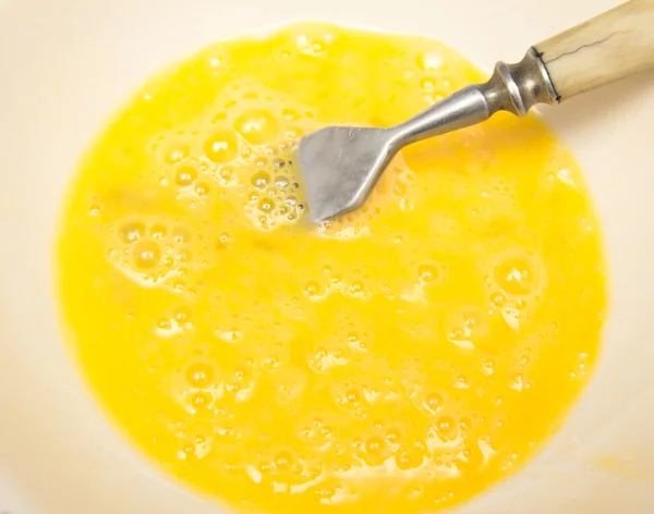 From egg yolk with a fork — Stock Photo, Image