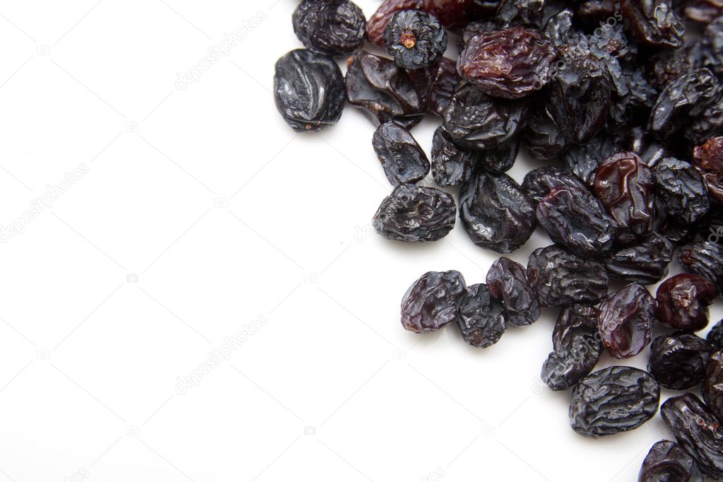 Black raisins on a white background
