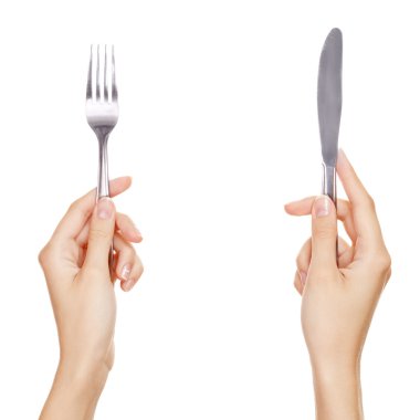 A knife and fork being held by womans hands. Isolated on white. clipart