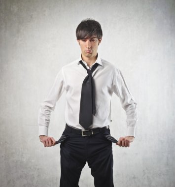 Sad young businessman turning his pockets inside out clipart