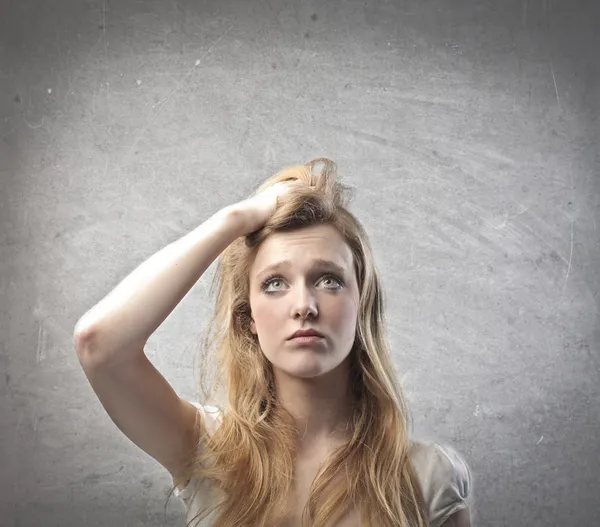 Young woman with doubtful expression — Stock Photo, Image