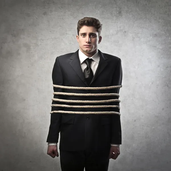 Jovem empresário amarrado com cordas — Fotografia de Stock