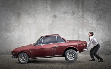 Man trying to lift a car clipart