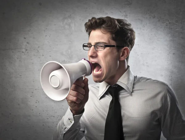 Giovane uomo d'affari urlando in un megafono — Foto Stock