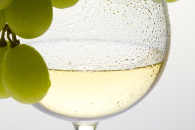 Wineglass with white wine and grape clipart