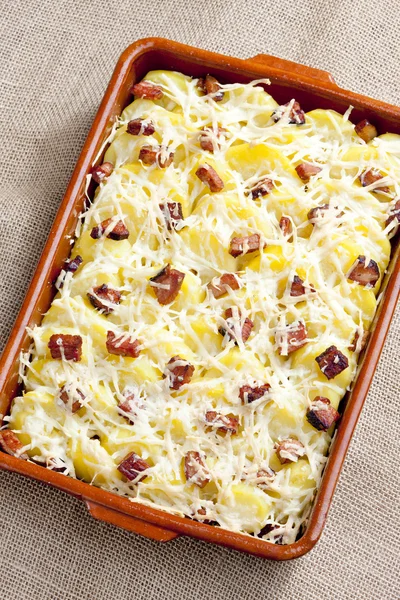Potatoes and bacon baked with pecorino cheese — Stock Photo, Image