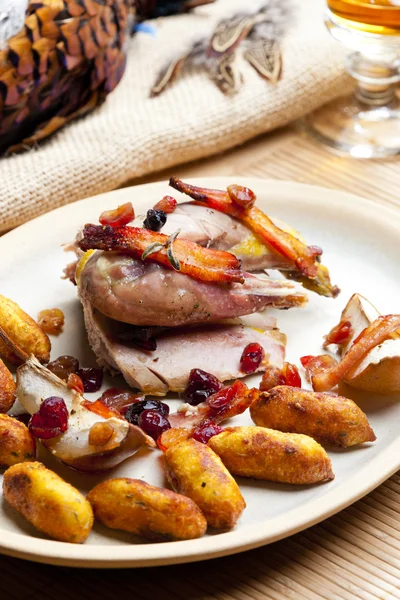 stock image Baked pheasant with bacon, pear, raisins on brandy