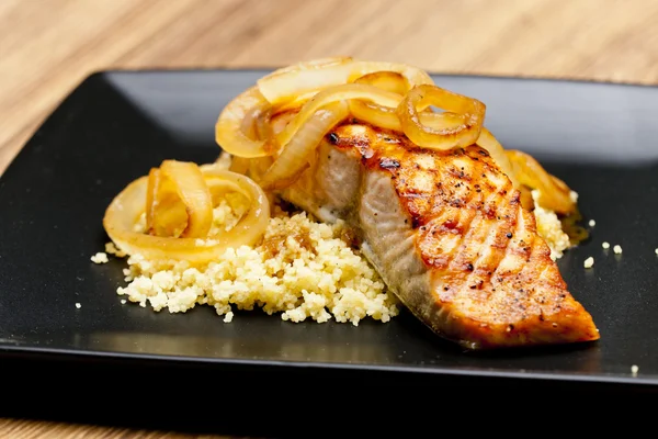 Grilled salmon with burned onion and couscous — Stock Photo, Image