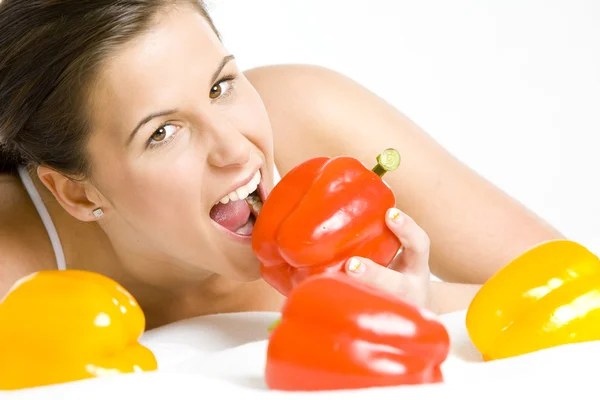 Portrait of lying down woman with peppers — Stock Photo, Image