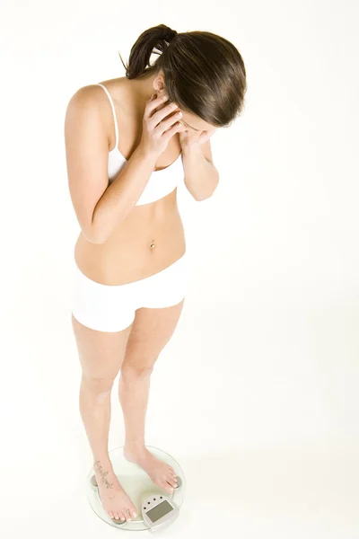 Mujer usando ropa interior de pie en la escala de peso — Foto de Stock