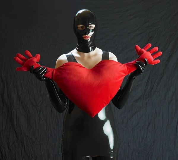 Woman in latex with heart — Stock Photo, Image