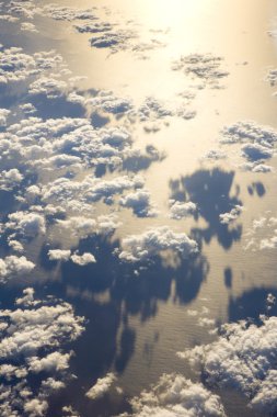 Clouds above ocean - view from plane clipart