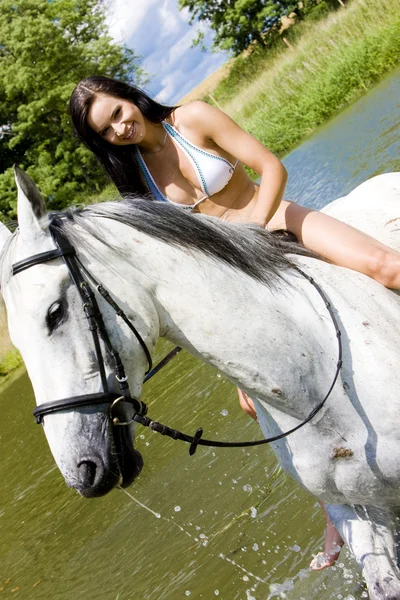 Equestrian on horseback riding through water — Stock Photo, Image