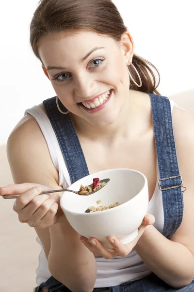 Portrait of woman eating cereals - Stok İmaj