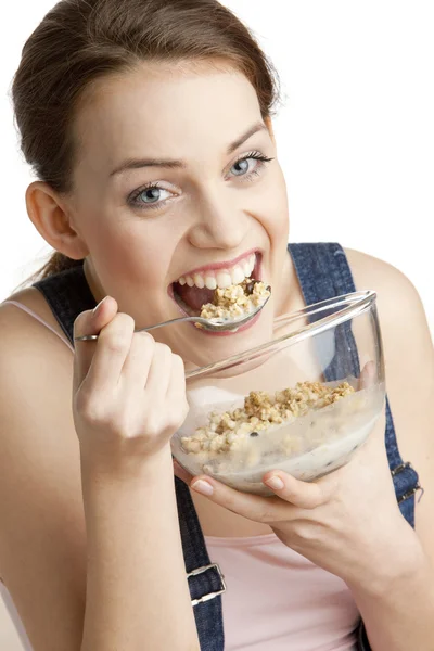 Portrait of woman eating cereals Stok Fotoğraf