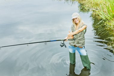 Woman fishing in pond clipart