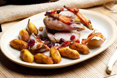 Baked pheasant with bacon, pear, raisins on brandy clipart