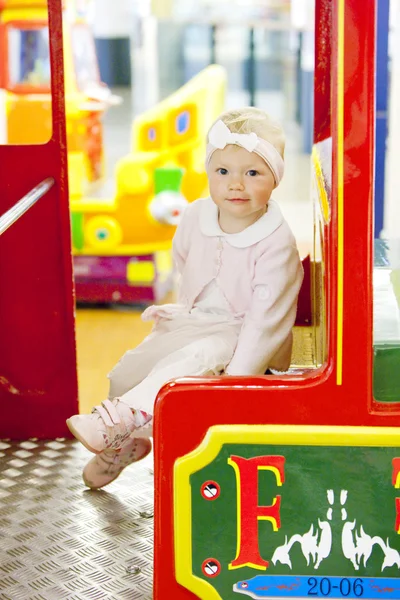 Sitting toddler on carousel — Stock Photo, Image