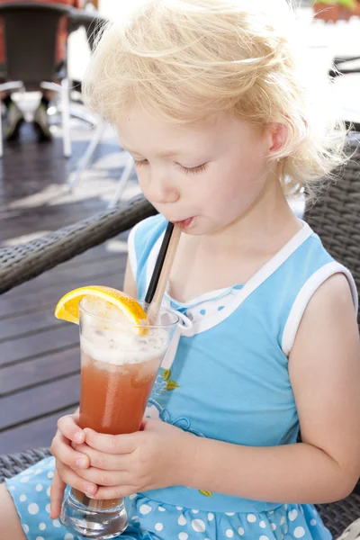 Portrait of little girl with a glass of cocktail — Stock Photo, Image