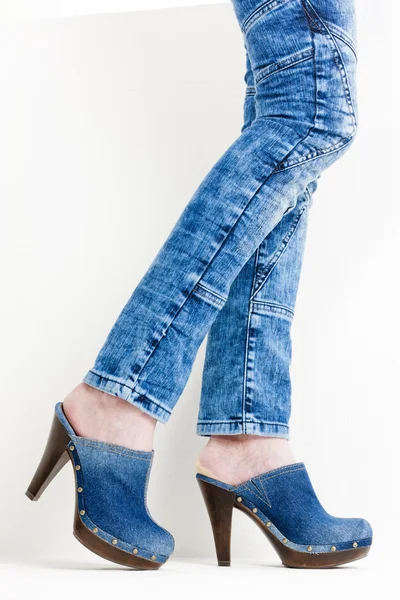 Детали женщины, носящей джинсовые сабо — стоковое фото