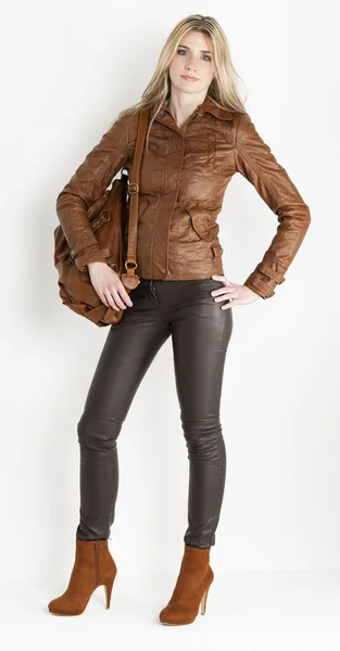Stående kvinna klädd i bruna kläder och fashionabla bruna skor — Stockfoto
