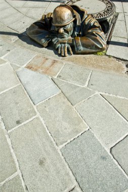 Bronze sculpture called man at work, Bratislava, Slovakia clipart