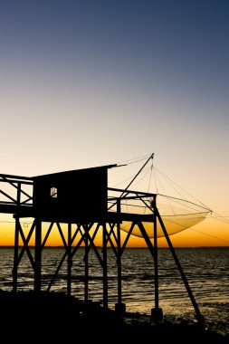 Pier with fishing net during sunrise, Gironde Department, Aquita