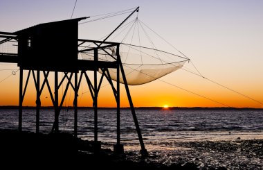 Pier with fishing net during sunrise, Gironde Department, Aquita clipart