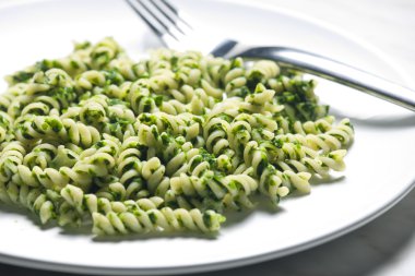 Pasta fussili with spinach clipart