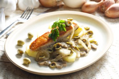 Baked salmon on champignons, onion and olives clipart