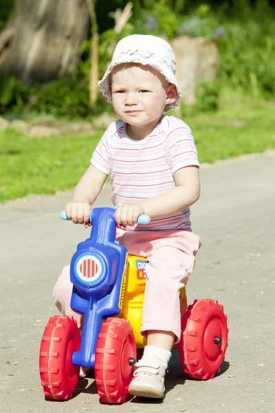 Little girl on toy motorcycle — Stock Photo, Image