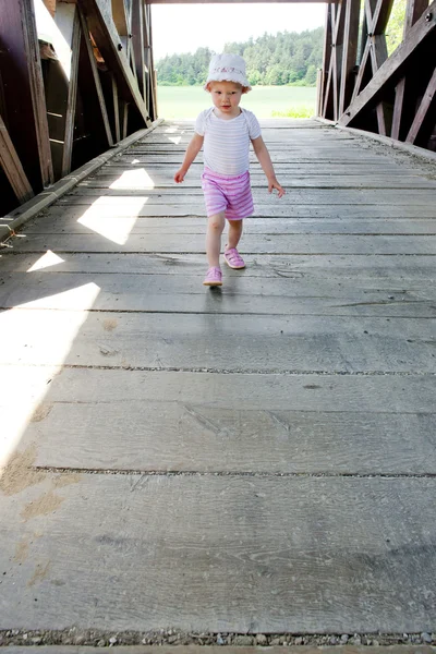 Little girl on covered wooden bridge, Stefanska huta, Slovakia — Stock Photo, Image