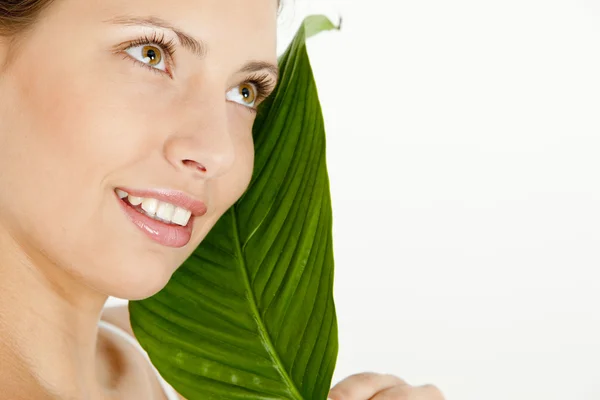 Portrait of young woman with a leaf — Stock Photo, Image