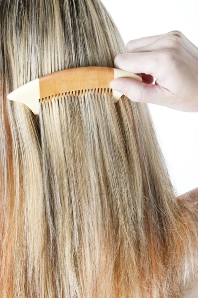 Detail of woman combing long hair — Stock Photo, Image