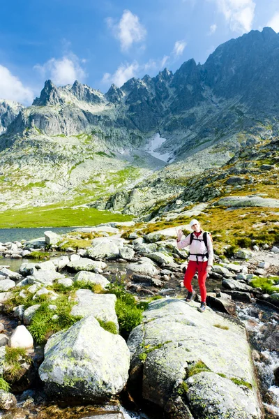 stock image Woman backpacker at Five Spis Tarns, Vysoke Tatry (High Tatras),