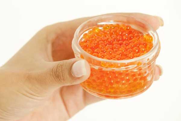 Woman's hand holding bowl with red caviar — Stock Photo, Image