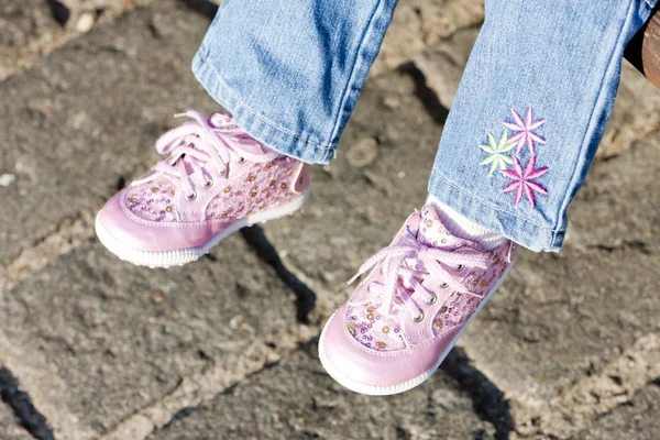 Detail sedící dívka, která nosí růžové boty — Stock fotografie