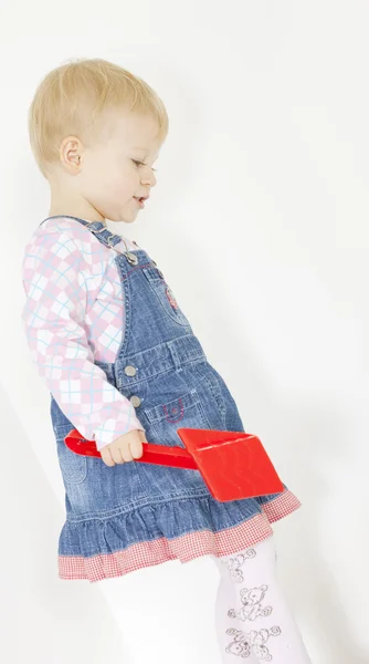 Standing toddler with a scoop — Stock Photo, Image