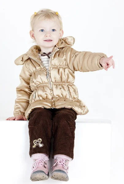 Sitting little girl wearing jacket — Stock Photo, Image