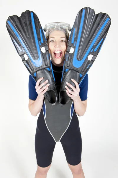 Standing young woman wearing neoprene with flippers and diving g — Stock Photo, Image