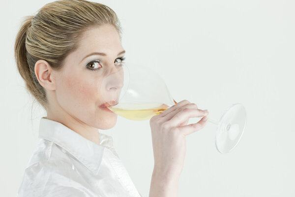 Portrait of young woman drinking white wine