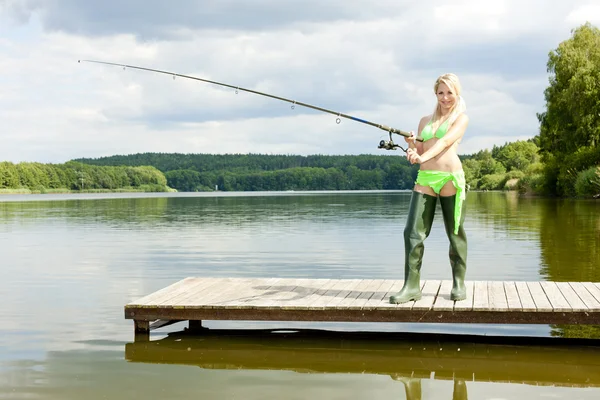 Fishing woman standing on pier — Stock Photo, Image