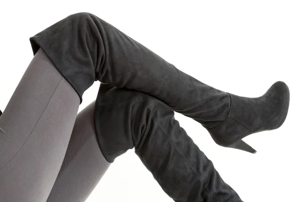 Detail of sitting woman wearing fashionable black boots — Stock Photo, Image