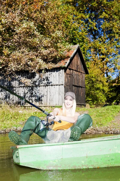 Fishing woman sitting on boat — Stock Photo, Image