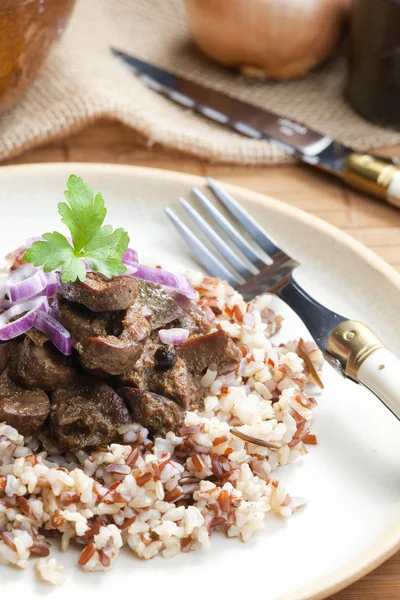Pork kidney on onion with wild rice — Stock Image Pork kidney on onion with wild rice Royalty Free Stock Photos